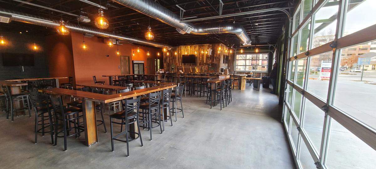 Furnishings made from reclaimed wood help create a warm, inviting atmosphere at Mother Earth Brew Co.’s new tap house.