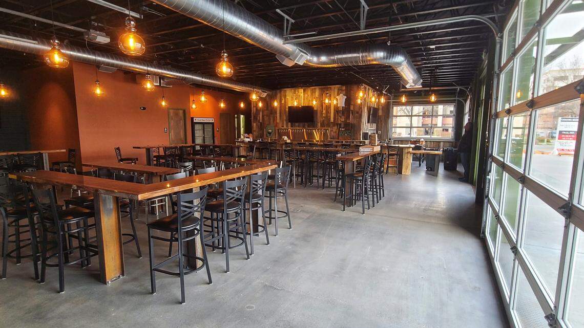 Furnishings made from reclaimed wood help create a warm, inviting atmosphere at Mother Earth Brew Co.’s new tap house.