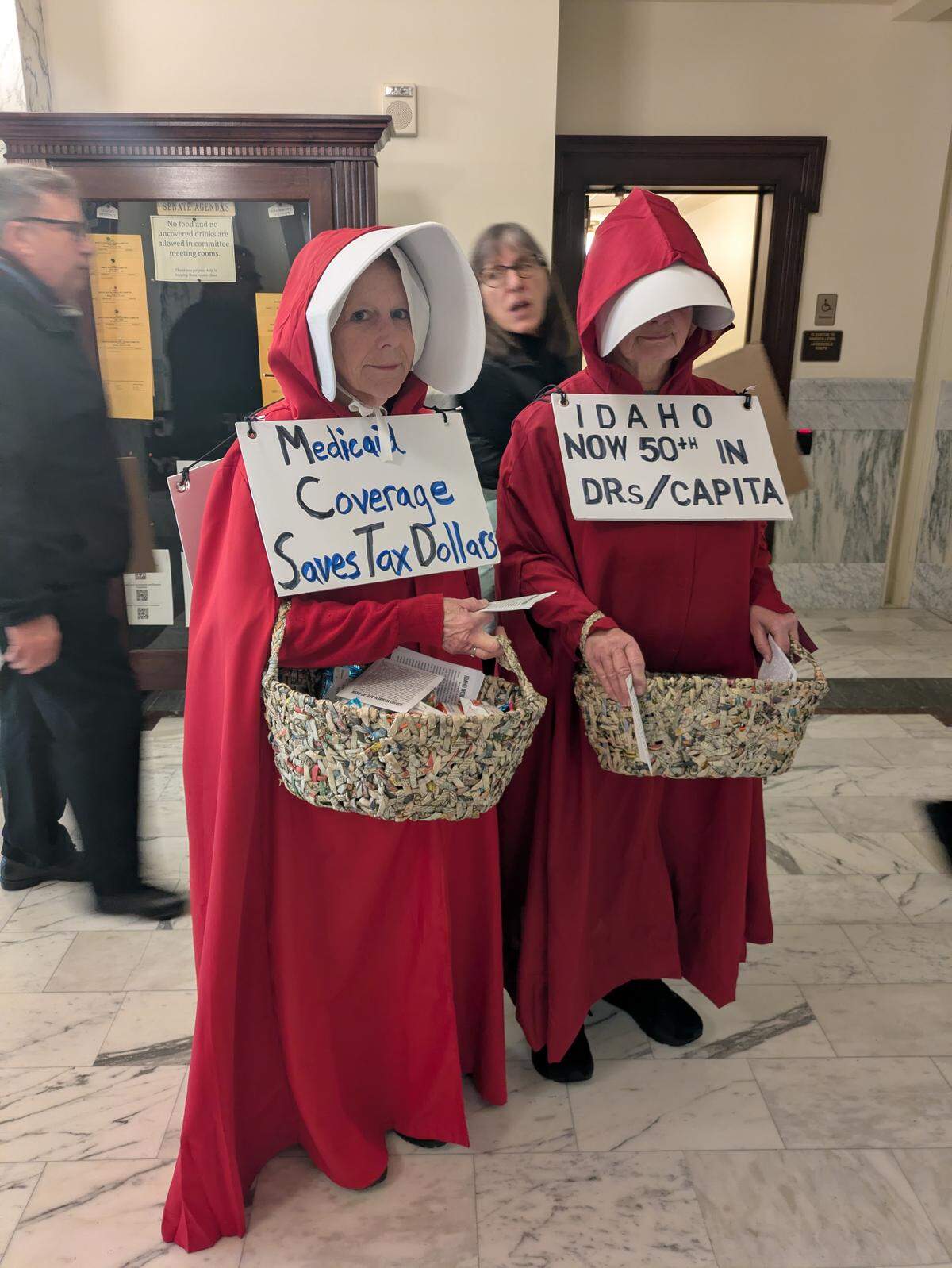 Paula Lewis, 65, and Alison Reddy, 67, both Boise residents, came to the Idaho Legislature on January 12 with signs about Medicaid and health care. 