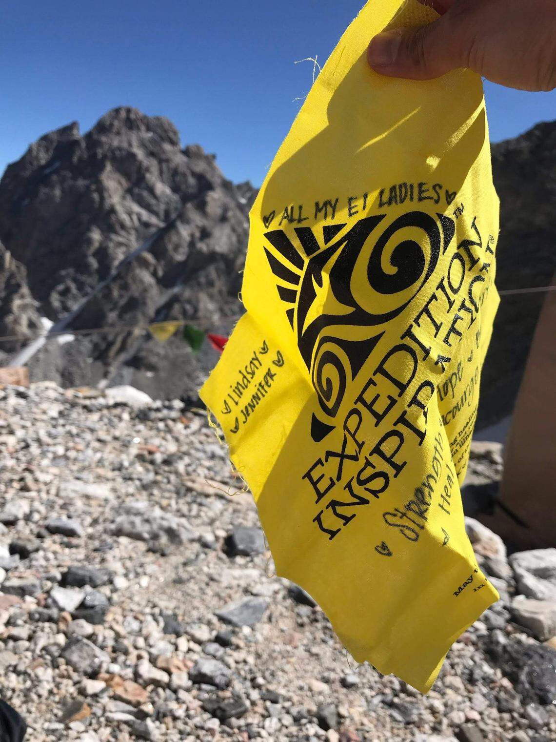 Tonya Hylton holds a tribute flag during the Expedition Inspiration hike on the Grand Teton in July 2019. Tribute flags are used often in mountaineering, and the Idaho nonprofit has adopted them as a way to tribute breast cancer survivors or lost loved ones.