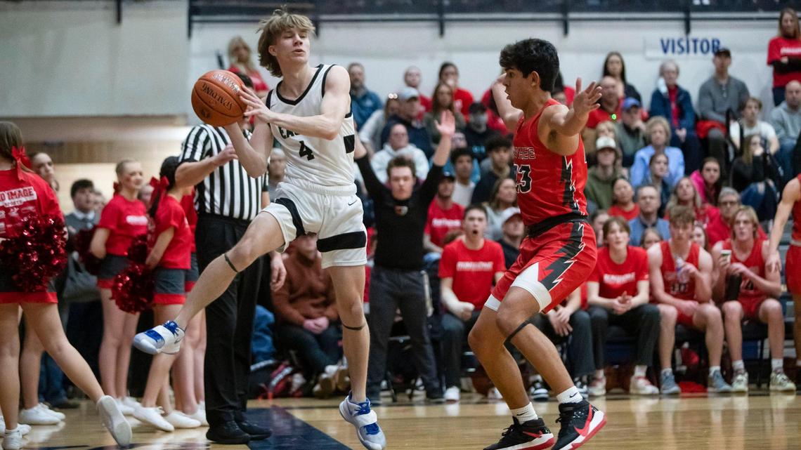 Eagle guard Tyler Peters looks for passing options as he keeps a toe inbound while defended by Owyhee’s Titus Bailey in the 5A District Three championship Friday at Meridian High School.