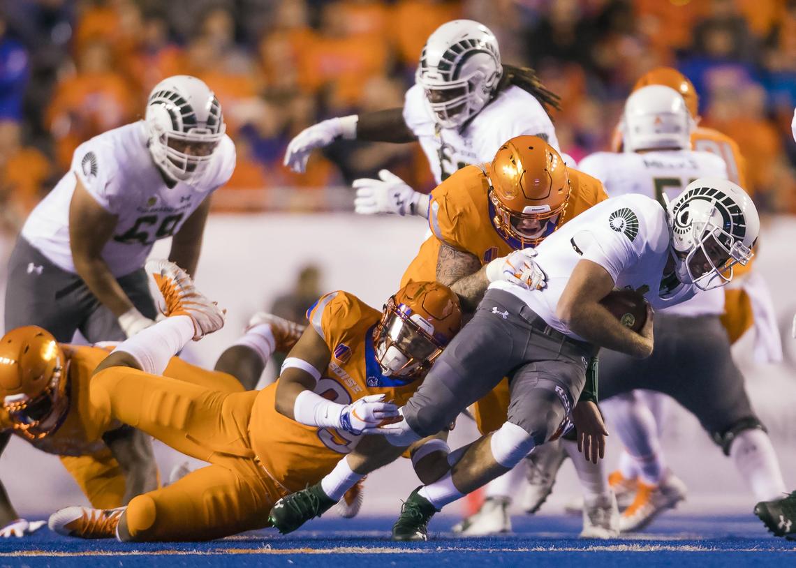 Boise State linebacker Curtis Weaver and defensive tackle Chase Hatada sack Colorado State quarterback K.J. Carta-Samuels earlier this season at Albertsons Stadium in Boise.