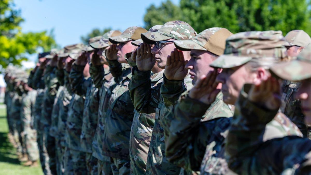 The Idaho National Guard’s citizen-soilders salute during the singing of the National Anthem at a ceremony in June 2024 at Gowen Field.