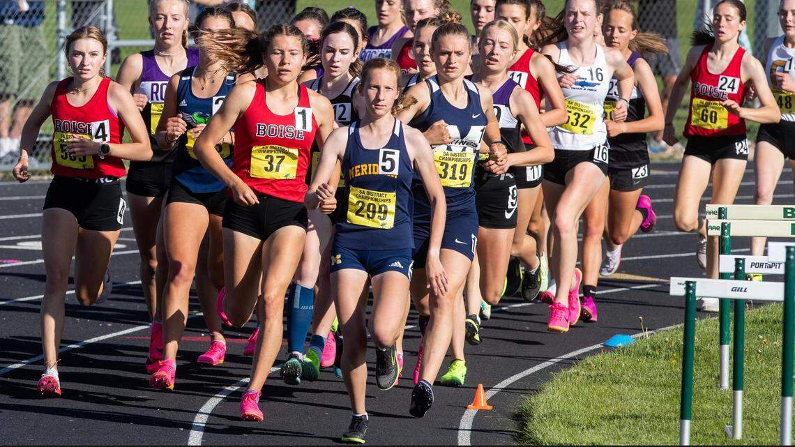 Girls run the 1,600 meters Friday at the 5A District Three track and field championships held at Kuna High. Allie Bruce of Boise High (No. 37) won the race and Aubrey Kohler of Meridian (299) came in second.