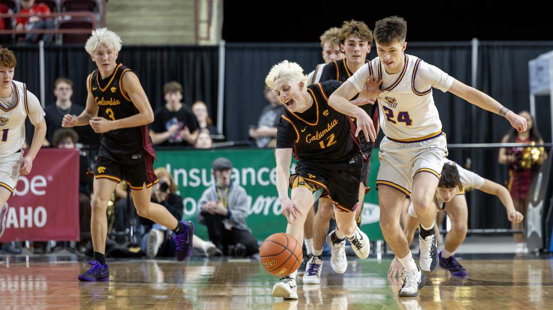 Columbia junior Wiatt Plugge and Lewiston junior Blaze Hepburn run for control of the loose ball during their 5A boys basketball state tournament semifinal game Friday at the Ford Idaho Center in Nampa.