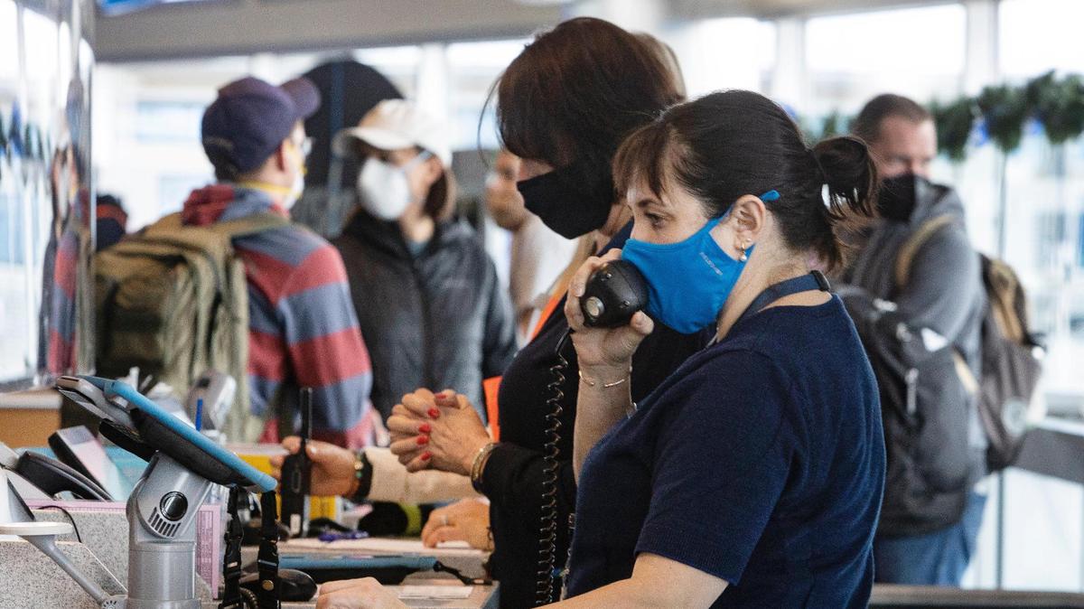 Gate agent Maria Bengoechea uses the intercom to make an announcement to passengers flying on Alaska Airlines at the Boise Airport on Wednesday, Jan. 5, 2021. Ken McClure, lobbyist for the Idaho Liability Reform Coalition, said the beginning of the pandemic attracted lawsuits on COVID-19 exposure against travel industries.