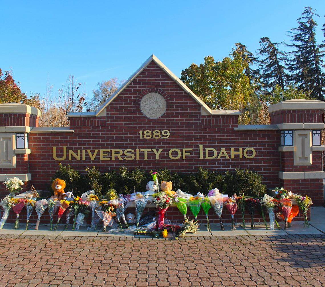 Tributes are lined up outside a sign along Pullman Road in Moscow to honor the four students who were killed in the early morning attack Nov. 13 at their rental house just off campus.