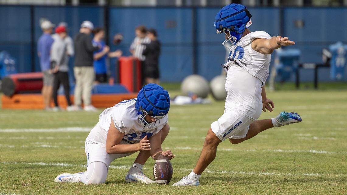 Boise State kicker Jarret Reeser, with punter Oscar Doyle holding, kicks a field goal during the Broncos' fall camp in Boise, Saturday, Aug. 9, 2025.