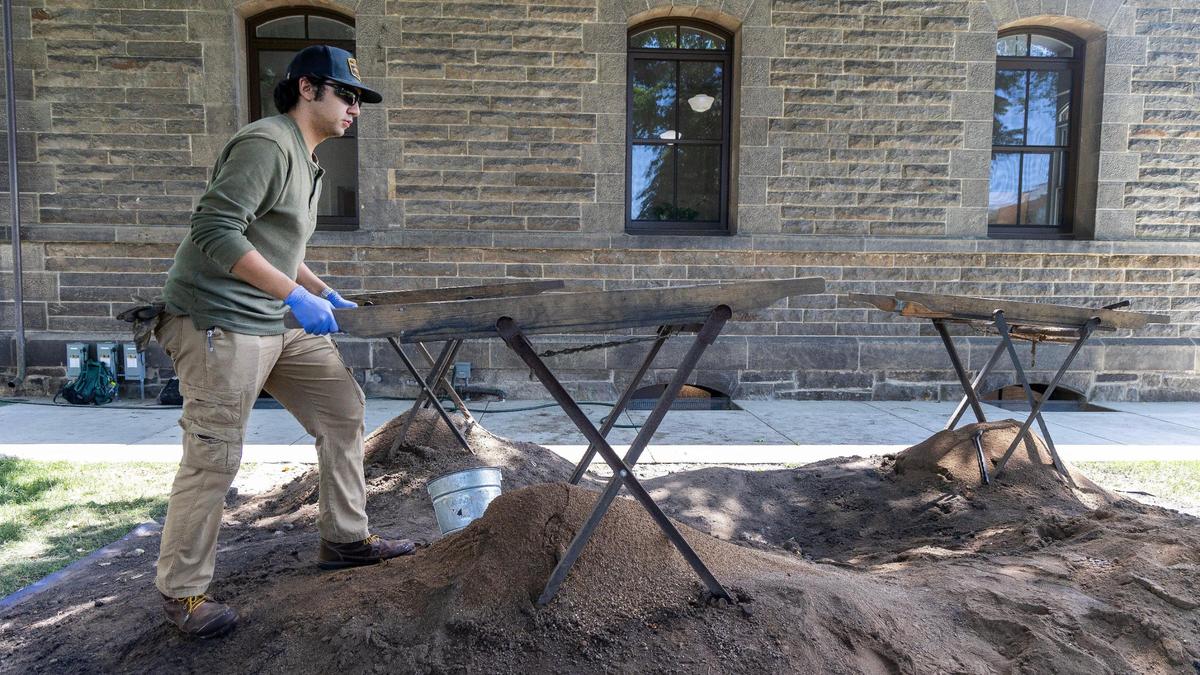 College of Western Idaho student Nate Biggs uses a screen to sift through dirt looking for artifacts at an archaeology dig outside of the State Historic Preservation Office.