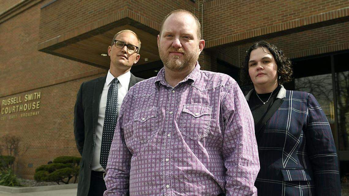 Randall Menges, along with his attorneys Matthew Strugar and Elizabeth Ehret, pause March 30 outside the Russell Smith Federal Courthouse in Missoula, Montana.