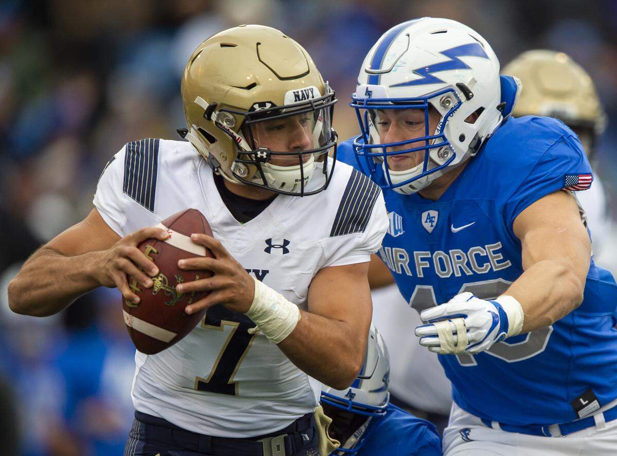 Navy quarterback Garret Lewis (7) tries to avoid the tackle from Air Force linebacker Kyle Johnson (40) Oct. 6 at Falcon Stadium at the U.S. Air Force Academy in Colorado Springs, Colo.