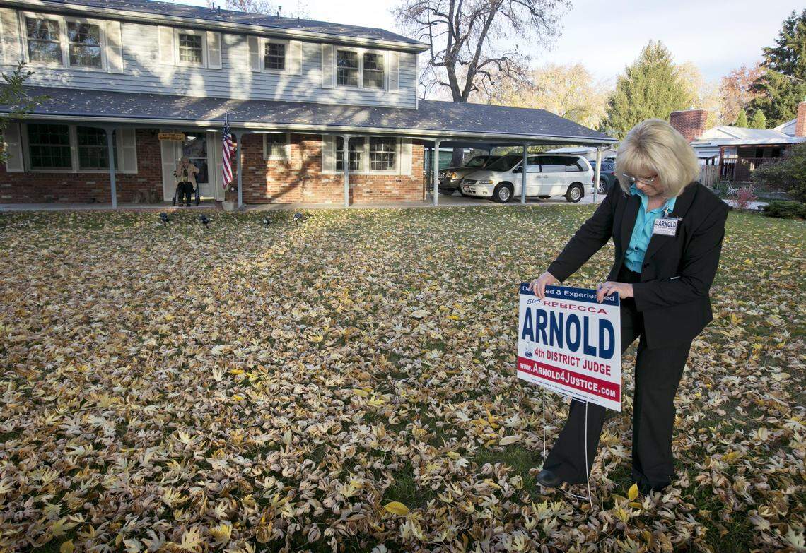 Rebecca Arnold leaves a voting sign in front of her former neighbor and long-time friend Naomi Christensen’s home in Boise while campaigning in October 2014 for a judgeship. Arnold lost.