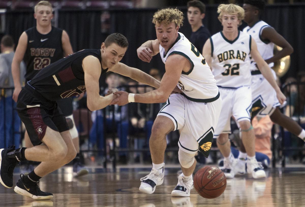 Borah senior Ellis Magnuson forces a turnover from Rigby’s Keegan Thompson in the 5A boys basketball state semifinals Friday at the Ford Idaho Center in Nampa.