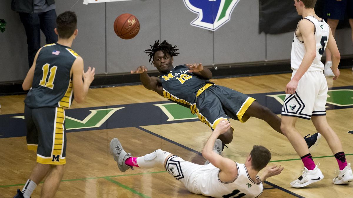Meridian freshman Davis Thacker gets a pass away to teammate Donovan Sanor after being fouled by Mountain View’s pressure Austin Smart (5) and Dallen Perrin Tuesday, Jan. 22, 2019 at Mountain View High School in Meridian. The two rival high schools were playing in the annual Stinky Sneaker boys basketball game. The Warriors of Meridian won the game 55-50.