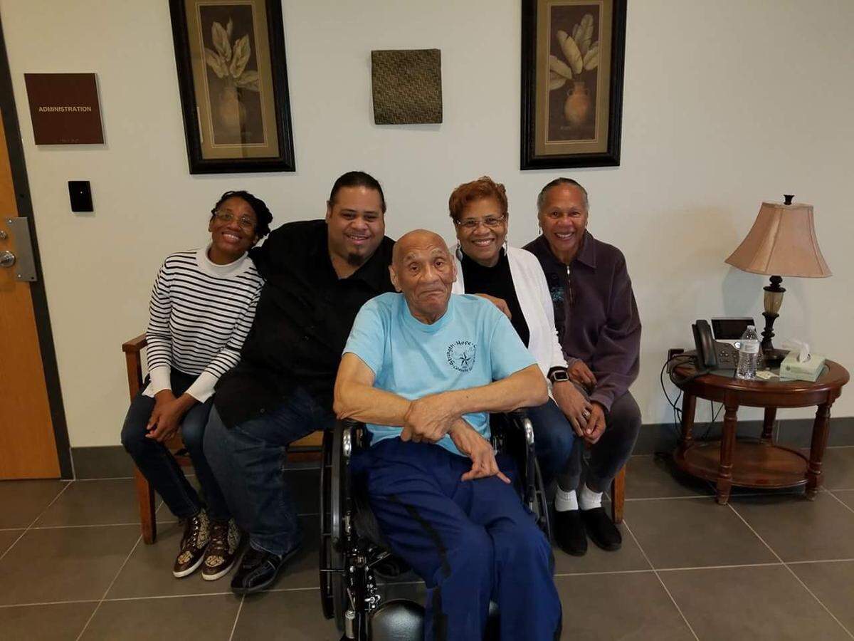 Kenneth Bowser (center) visits with (from left) grandchildren Tonya Cotton and Mark Cotton and daughters Sharon Van Leer and Janet Bowser at a locked forensic nursing home in St. Peter, Minn., in 2016. He was sent to the home after he fatally shot his son and caretaker, Larry, in 2015, and was deemed unfit to stand trial because of his dementia.
