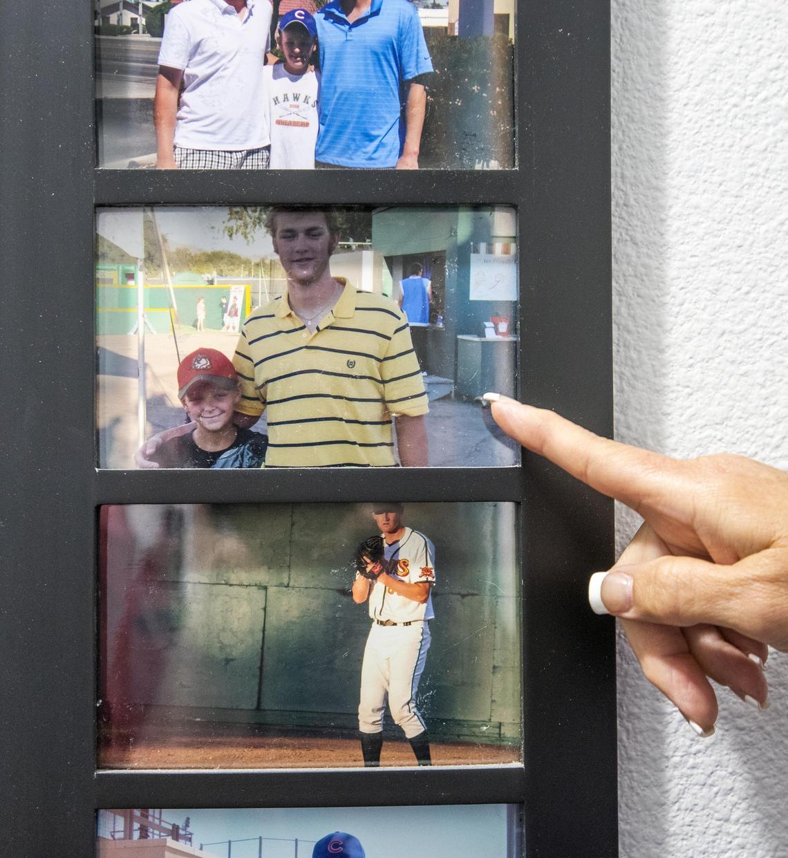 Sharon Knipe points to photos of former Boise Hawks athletes like Andrew Cashner, a 10-year MLB veteran now pitching for the Baltimore Orioles, with her son Ryan Knipe.