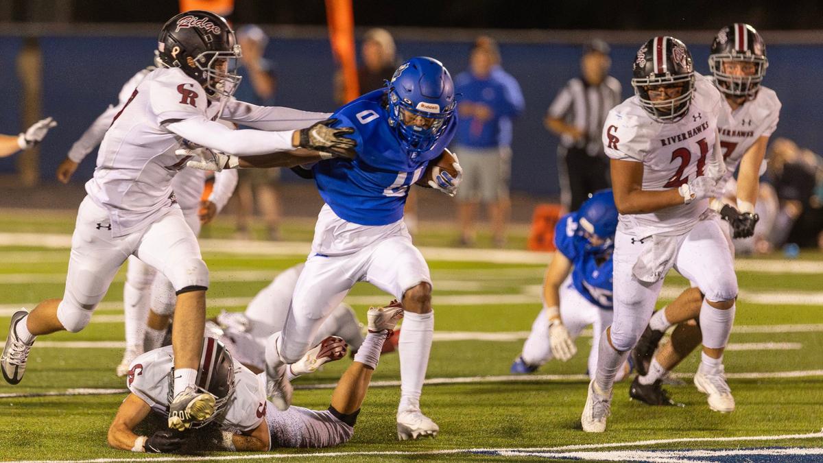 Emmett senior wide receiver Kenyon Carter fights through several arm tackles in the fourth quarter Friday.
