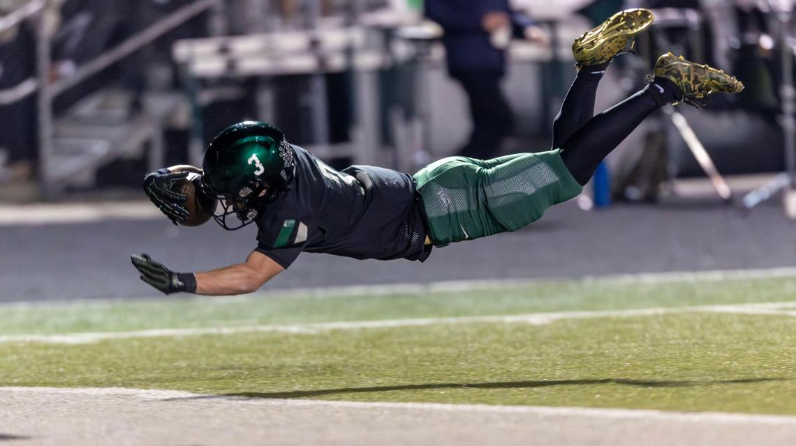 Eagle running back Noah Burnham finishes off a 44-yard touchdown run by leaping from the 5-yard line into the end zone. The Mustangs defeated Madison 22-16 in the 6A state quarterfinals.