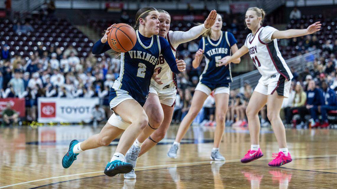 Middleton guard Olivia Blackwell drives by Rigby's Allie Dansie in the semifinals of the 6A girls basketball state tournament at Ford Idaho Center in Nampa, Friday, Feb. 20, 2026.