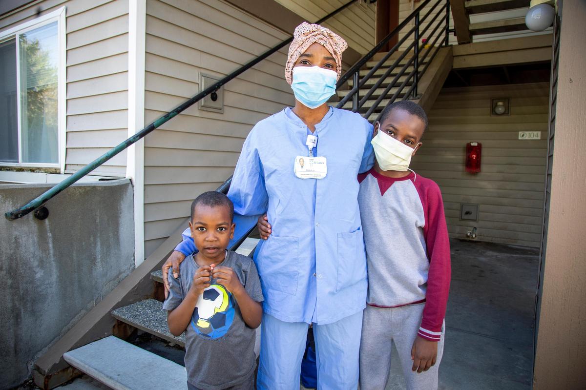 Nabila Hamid, a refugee from Sudan, is a single mom supporting her two sons, Adam Ahmed, 6, left, and Saghl Khamis, 10. She works as EVS techs (Environmental Services Technicians) in the St. Luke’s health system, cleaning and disinfecting hospitals. A program at IRC helps refugees like Hamid get training for higher paying jobs, and now she fills an increasingly crucial and sometimes hazardous role keeping hospitals and the Treasure Valley community safe during coronavirus.