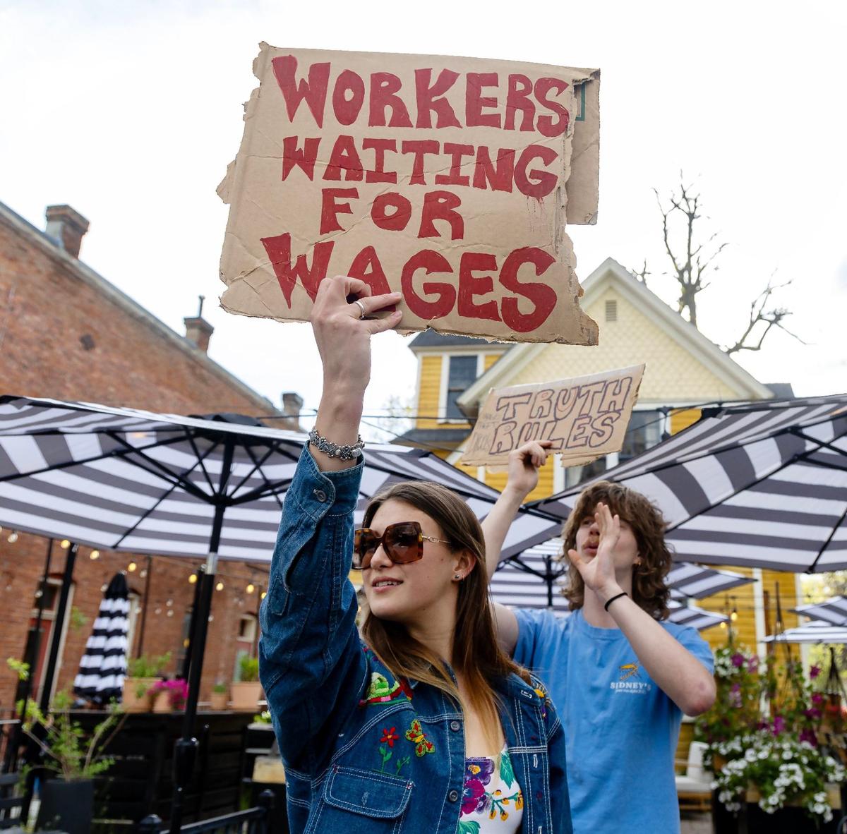 Former employee Ella Hoffhine picketed in front of Apericena, a restaurant in Boise accused of not paying its workers, in April. The restaurant has been shuttered and facing eviction since October.