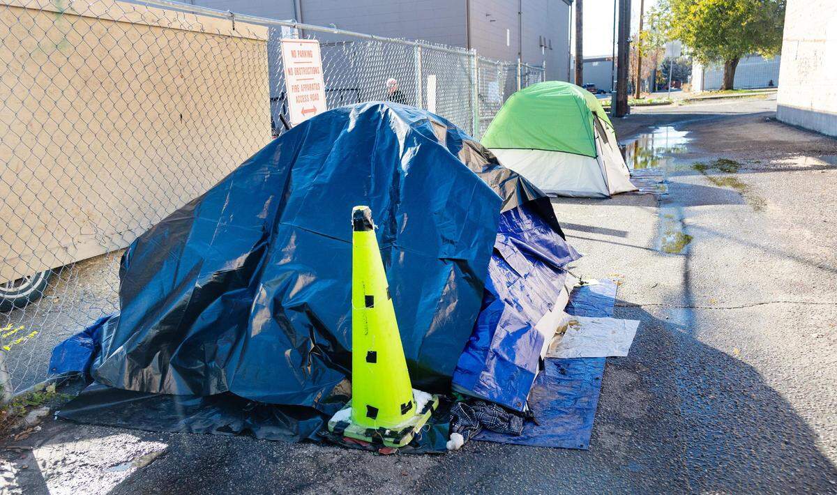 Tents are set up along Cooper Court, an alley frequented by people without homes. On Monday, lawmakers advanced a bill to ban “unauthorized” camping on public property.