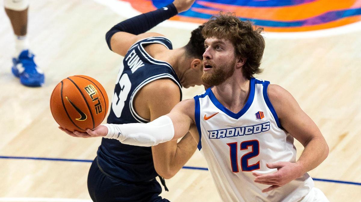 Boise State guard Max Rice scores on Utah State forward Taylor Funk in the second half Jan. 7 at ExtraMile Arena in Boise.
