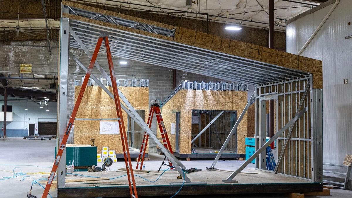 Without the struggles of road closures and inclement weather, Mountain Modular workers, subcontractors and inspectors create living space units at its warehouse in Boise.