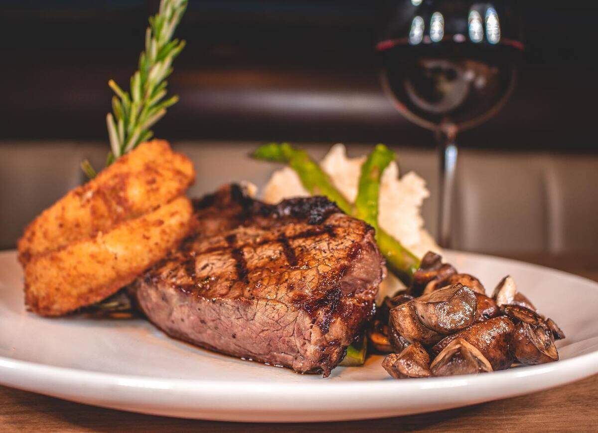 The Ribeye (16-ounce cut, mashed potatoes, sautéed mushrooms and grilled asparagus, $42. Cowboy Style is available at an additional cost).