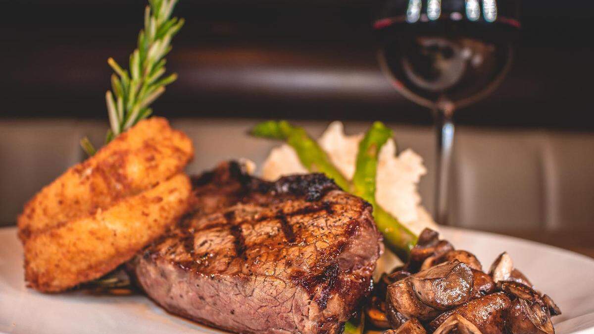 The Ribeye (16-ounce cut, mashed potatoes, sautéed mushrooms and grilled asparagus, $48. Cowboy Style is available at an additional cost).