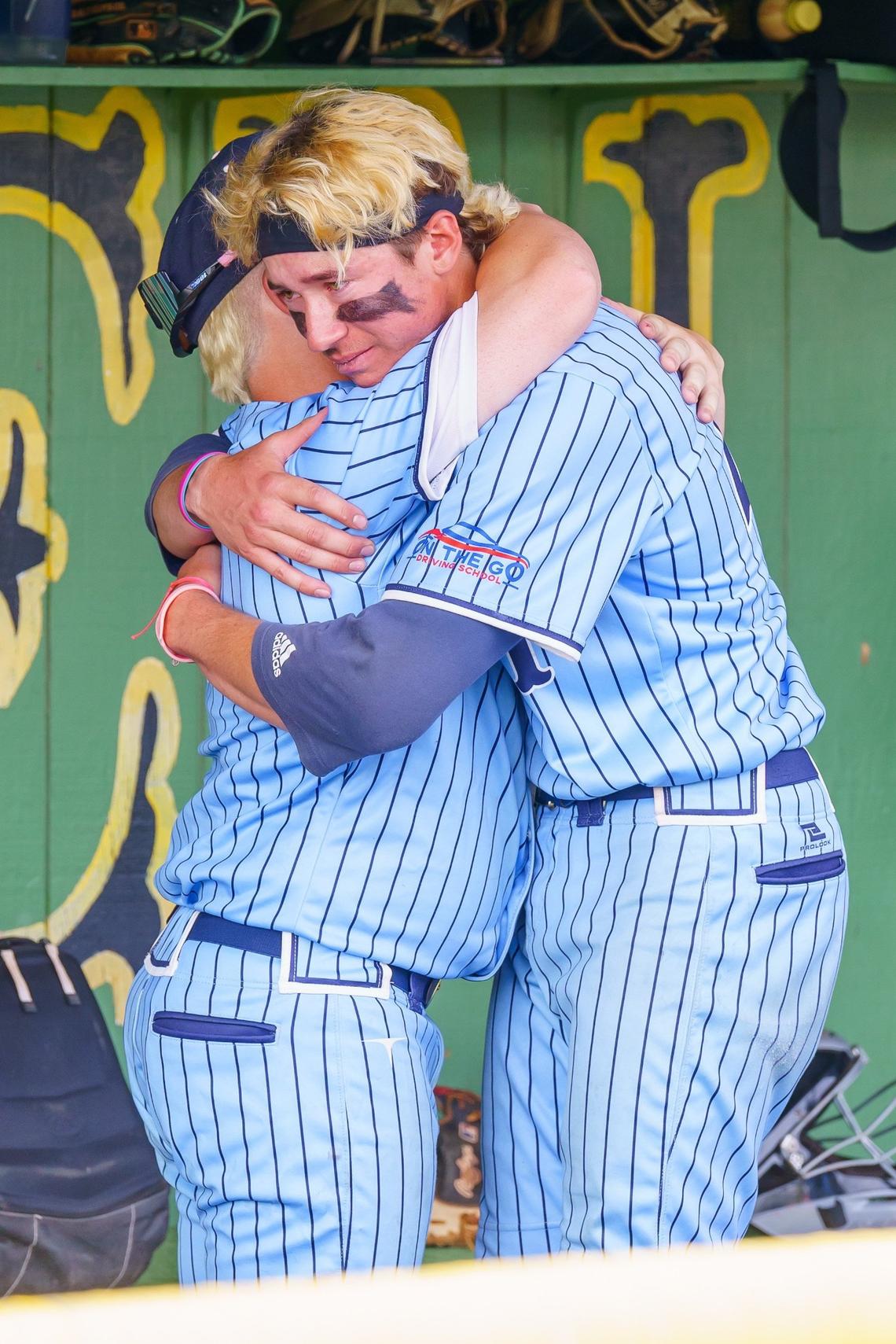 Skyview freshman Tyler Russell, left, and senior Vinny Caringella console each other after losing 14-4 to Pocatello on Saturday. Caringella had one of the Hawks’ six hits.