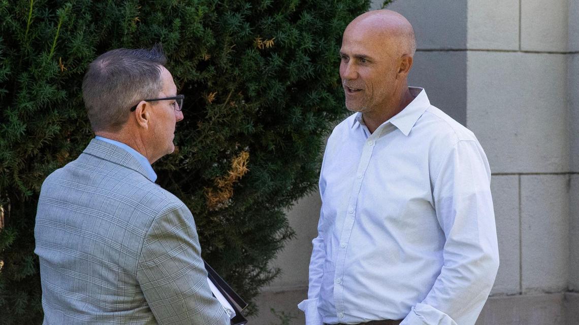 Aaron Welling, a friend of Ammon Bundy, talks with his legal counsel at the Gem County Courthouse.