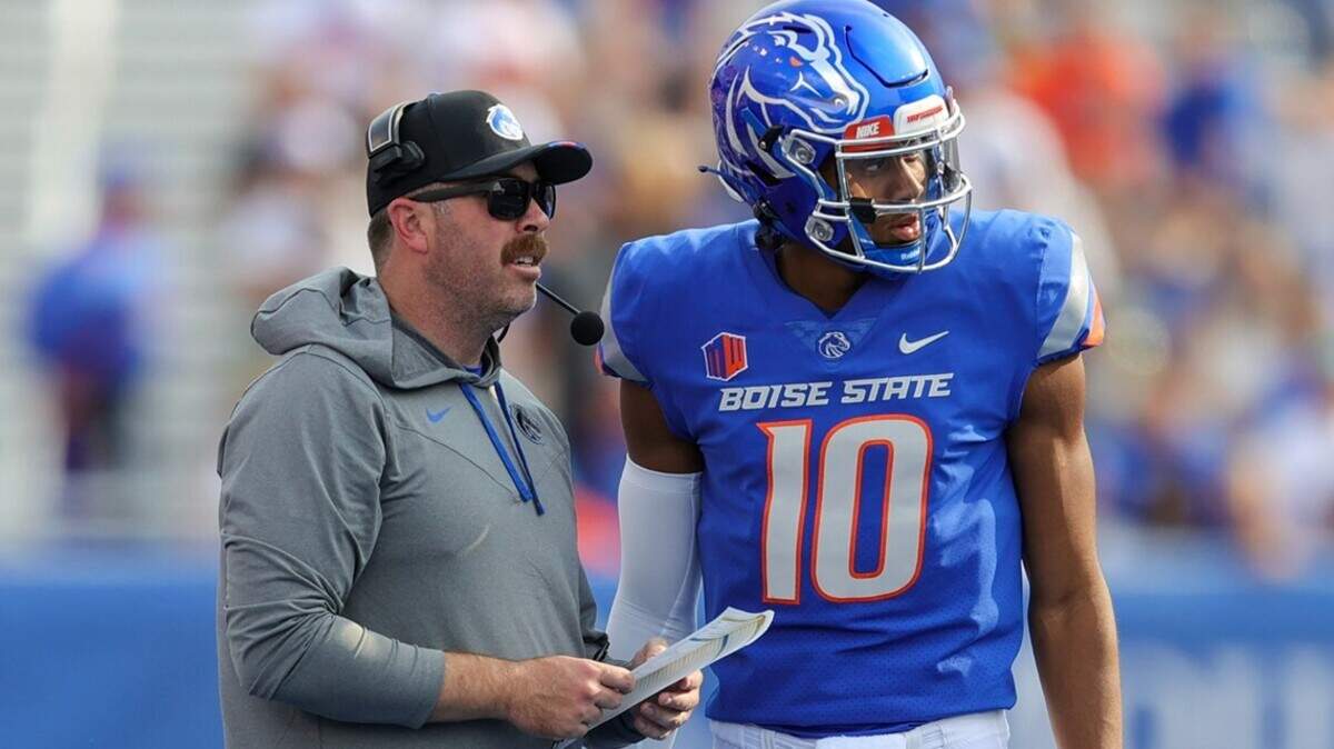 Former Boise State offensive coordinator Tim Plough goes over a play with quarterback Taylen Green this season. Plough was fired following a loss to UTEP in September.