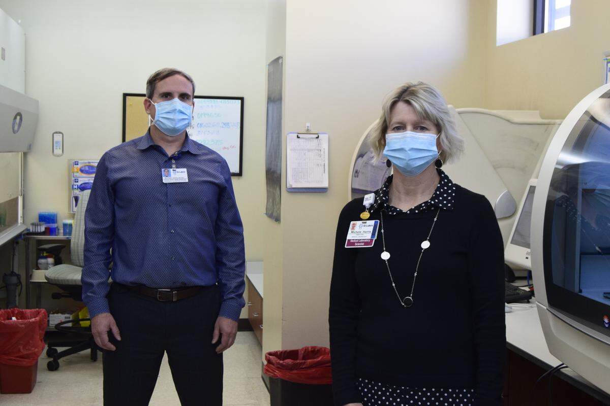 Matthew Burtelow, left, and Michele Harris are lab scientists at St. Luke’s Health System. Like other health care workers, they were under intense pressure over the last year of the coronavirus pandemic.