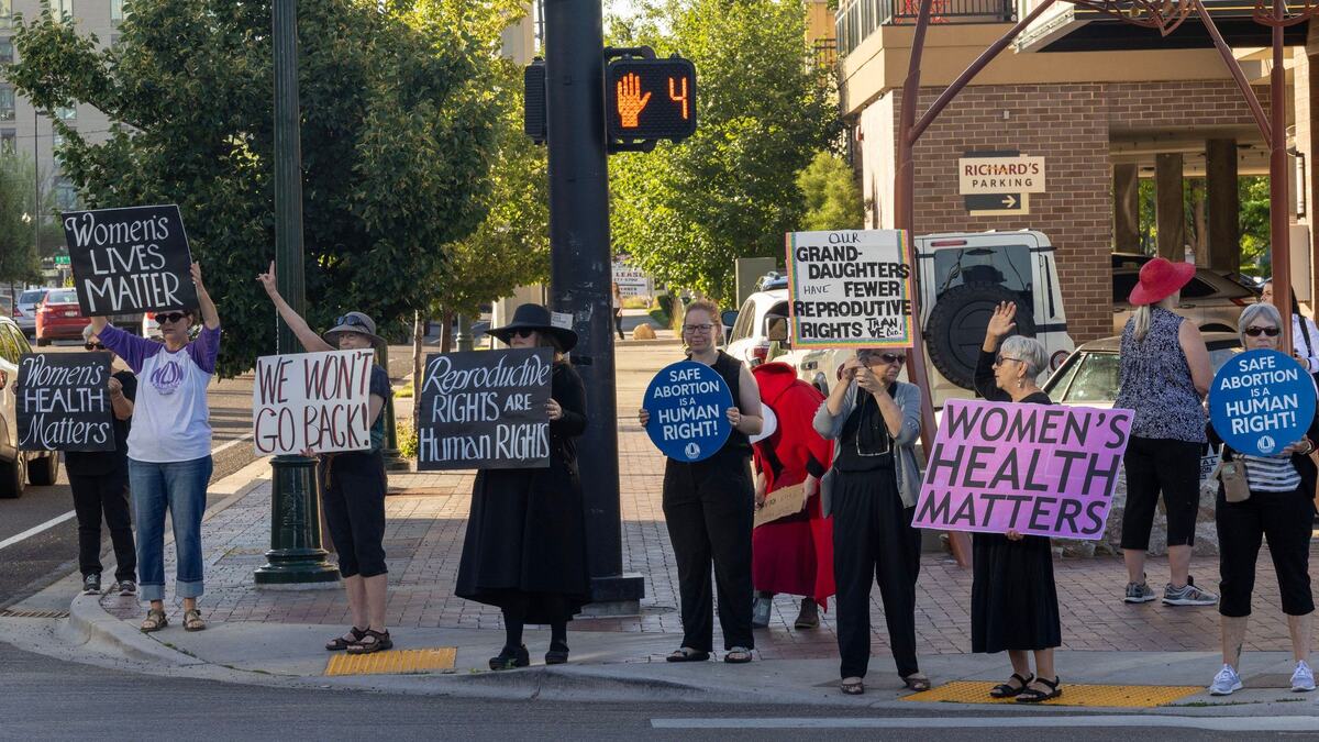 Holding signs decrying the state of women’s reproductive rights in Idaho, members of the Southwest Idaho Chapter of the National Organization for Women protest at the corner of Myrtle Street and Capitol Boulevard in downtown Boise.