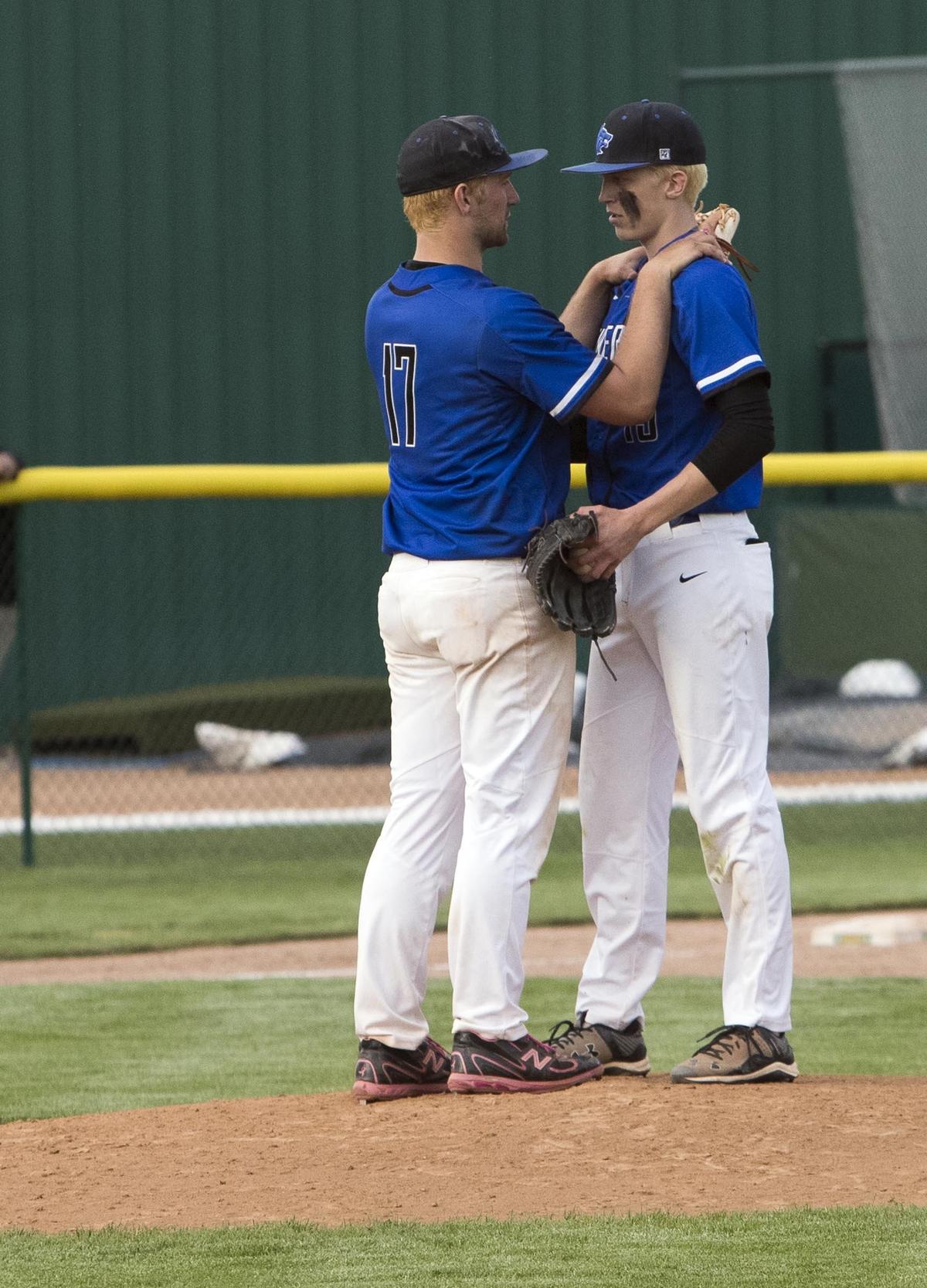 Timberline pitcher Jake Randall gives a pep talk to his replacement, Tomas Vizgirdas, with two outs and the bases loaded in bottom of the seventh inning Saturday. Randall had to leave the game because he reached his pitch count. Vizgirdas struck out the next batter to seal the Wolves' 7-3 victory over Bonneville and the 5A state title.