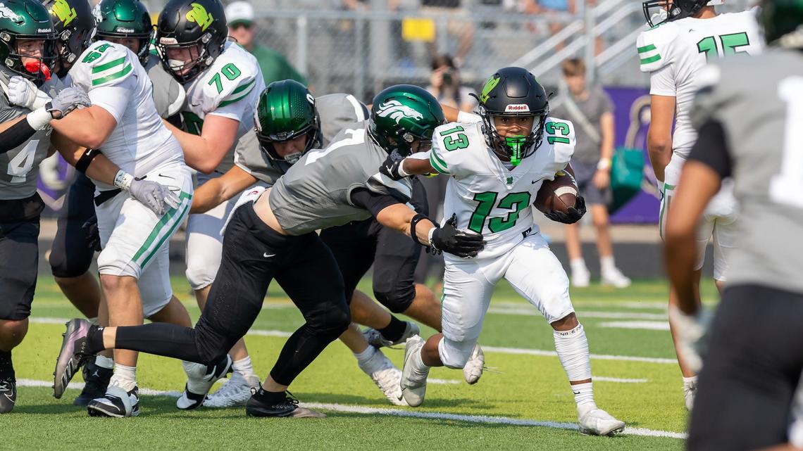 West Linn running back Viggo Anderson slips through the Eagle defense on Saturday.