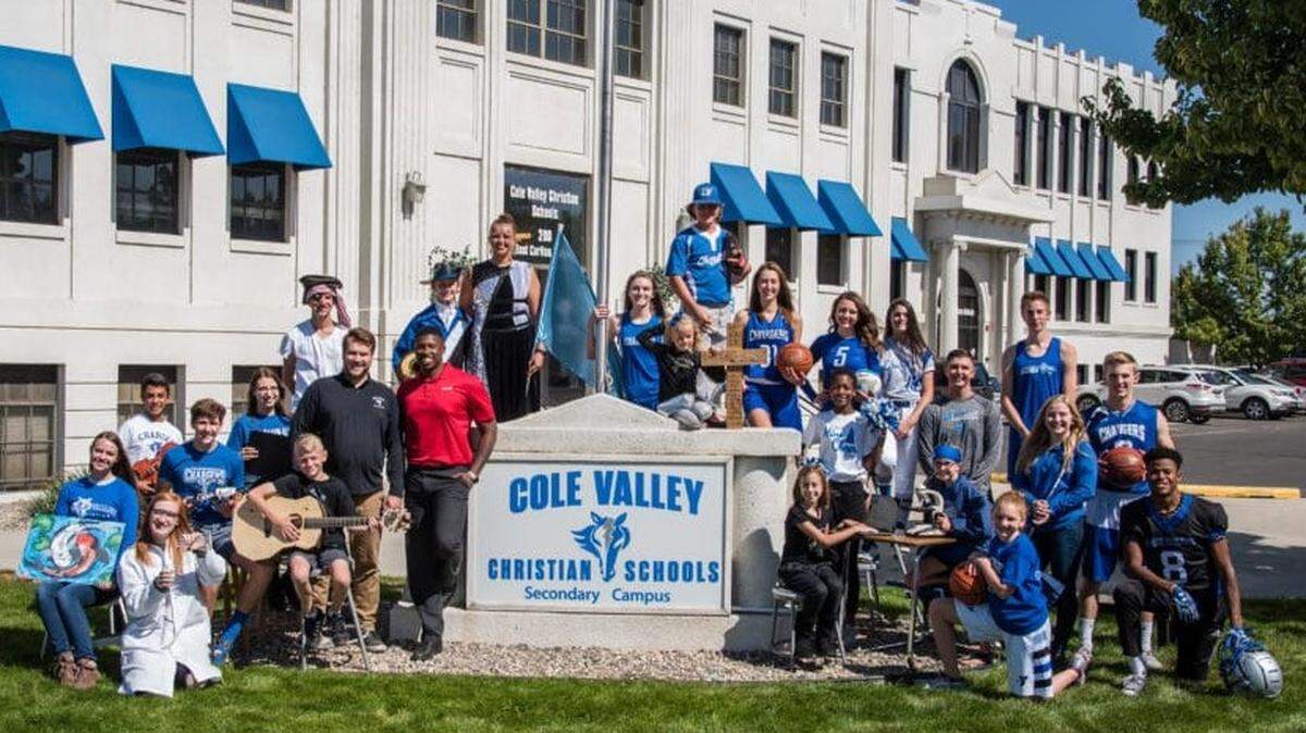 Students stand in front of the Cole Valley Christian High School in downtown Meridian. The school plans to sell the building once it has built its new campus.