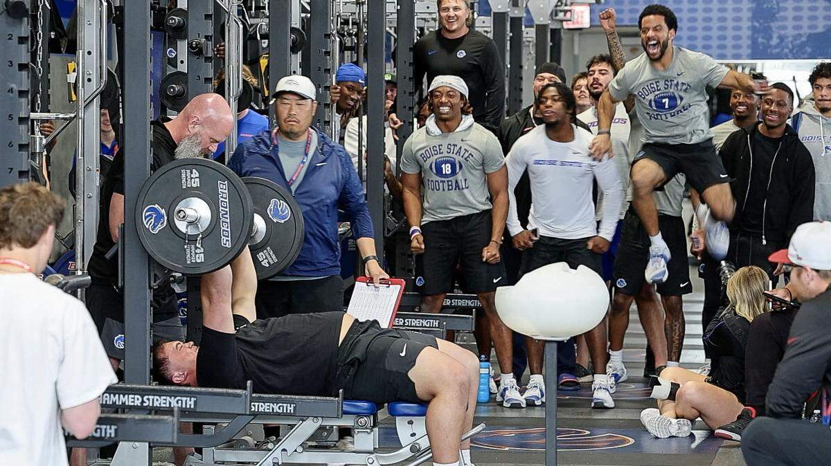 Former Boise State defensive lineman Braxton Fely channels cheers from teammates as he bench presses in front of a group of NFL scouts at Pro Day at the Bleymaier Football Center in Boise, Tuesday, March 24, 2026.