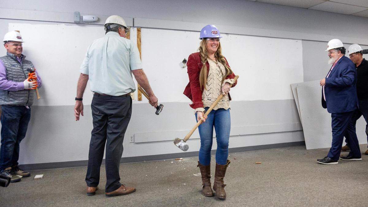 Jodi Peterson-Stigers, Interfaith Sanctuary’s Executive Director, reacts after making the first hole in the wall during the groundbreaking ceremony for construction of the new Interfaith Sanctuary homeless shelter at the former Salvation Army building, 4308 W. State St., Tuesday, April 18, 2023. The existing 30,000 square foot building will be remodeled to 42,500 sq. ft.