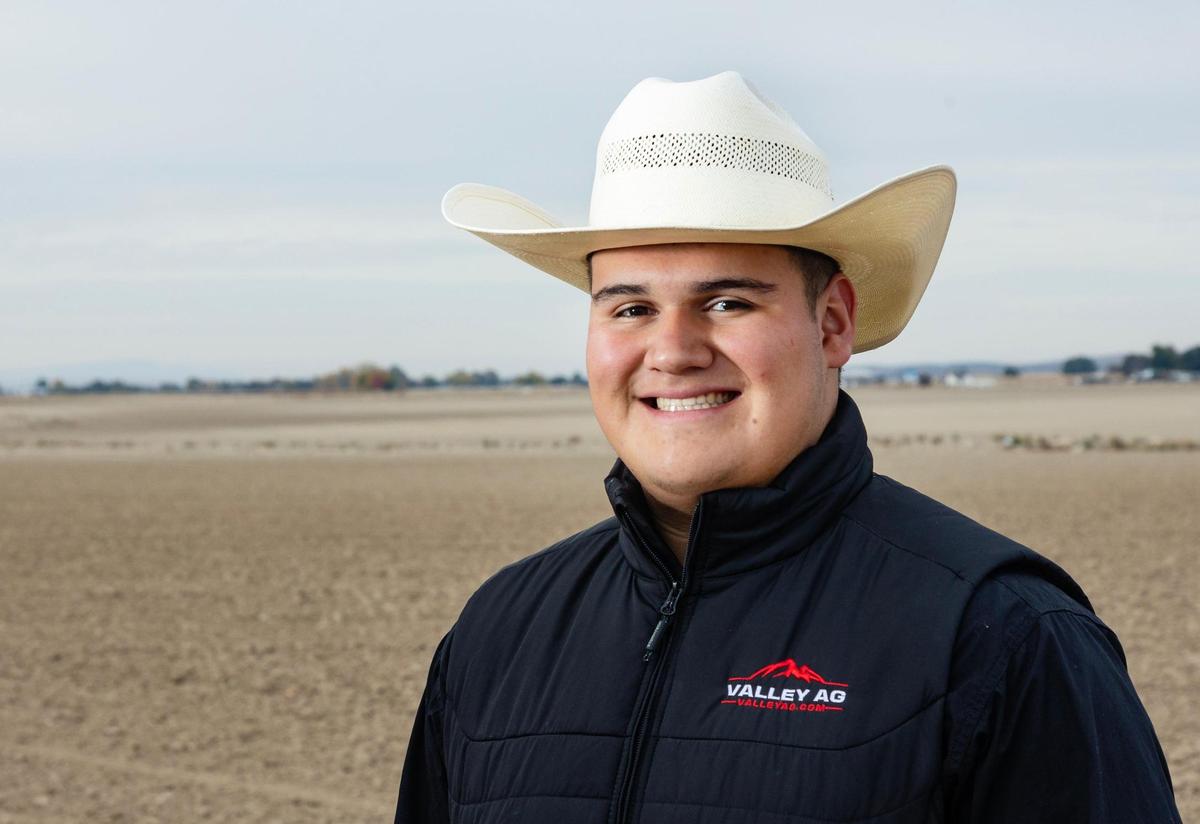 Notus High School senior Aaron Jimenez Guevara, 17, Is a farmworker at this wheat and corn field in Caldwell. Jimenez Guevara received a $64,000 scholarship from the College of Idaho this year. He and his sister Kim Jimenez Guevara are first-generation college students.