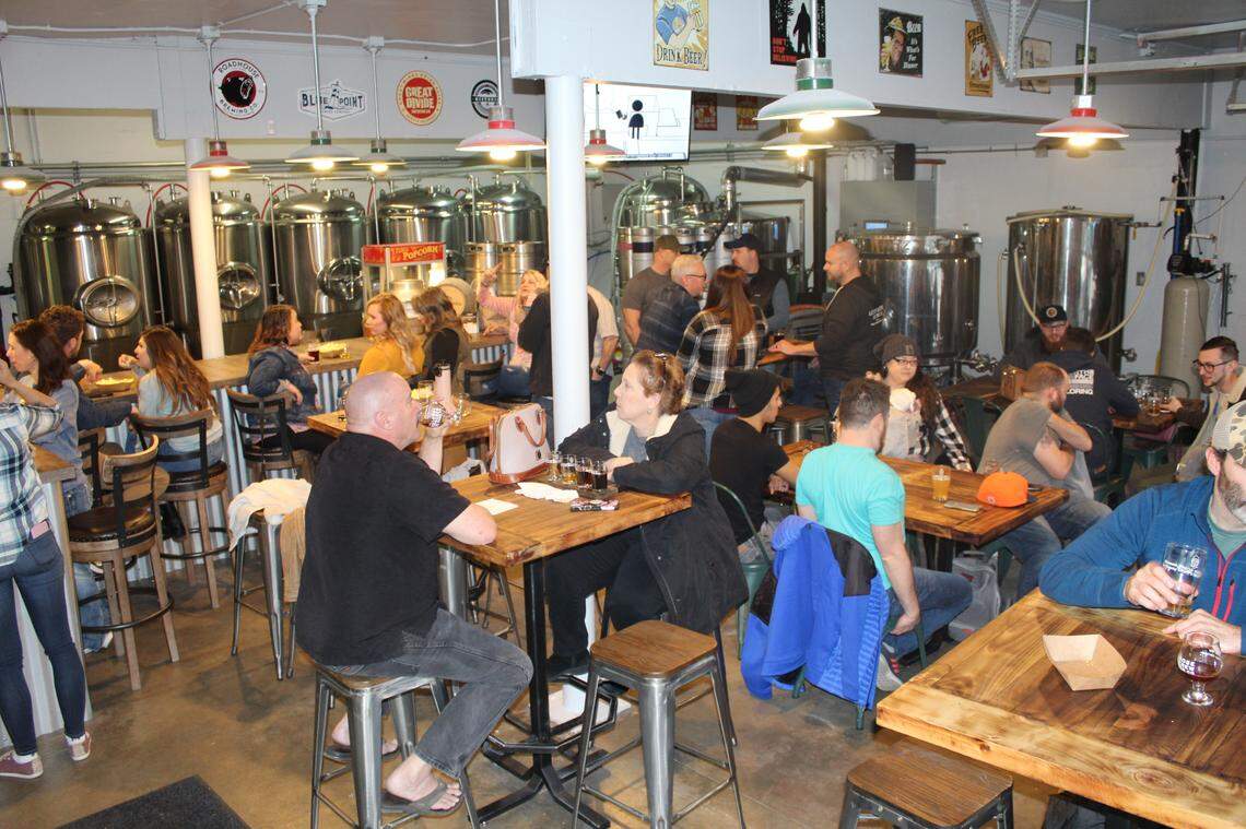 Customers socialize at Loose Screw Beer Co. in Garden City.
