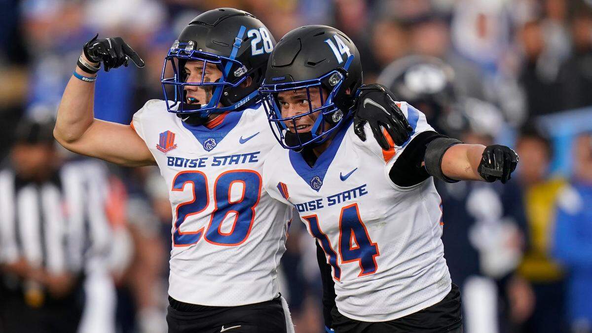 Boise State’s Kaonohi Kaniho, right, celebrates after his first career interception with older brother Kekaula Kaniho late in the fourth quarter of the Broncos’ 26-17 win over BYU in Provo, Utah.