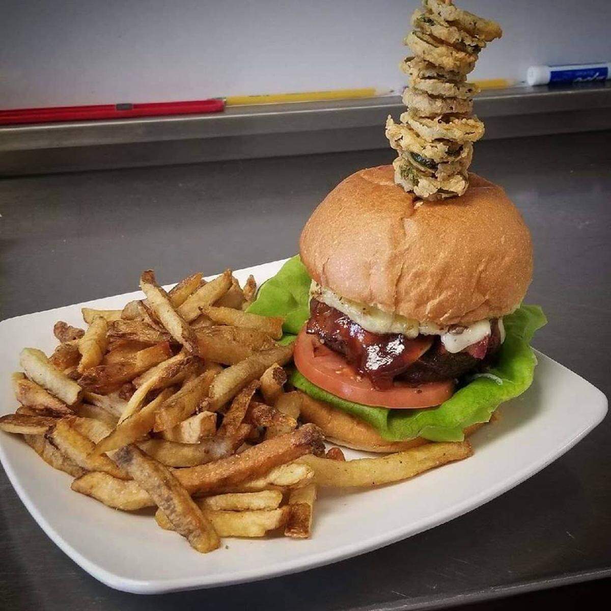 The Brixx Burger ($12) is an 8-ounce certified Angus patty with bacon, pineapple, gouda cheese, butterleaf lettuce, tomato, mayonnaise and barbecue sauce. Those are crispy jalapeno chips on top of it. The fries are hand-cut.