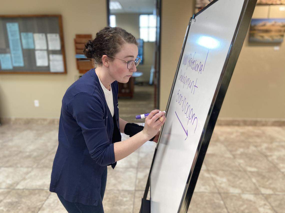 Jessica Bradley, an employee of the Eagle Parks and Recreation Department, helps set up for an event at City Hall, which had to be moved from the Eagle Landing community center after it Mayor Jason Pierce decided to temporarily close it.