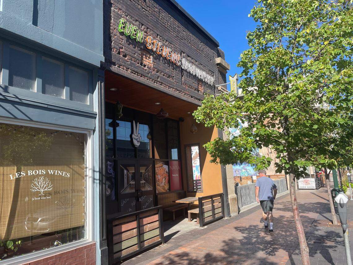 A man walks past the former Even Stevens sandwich shop in Boise, which now advertises Nara Ramen in the windows.