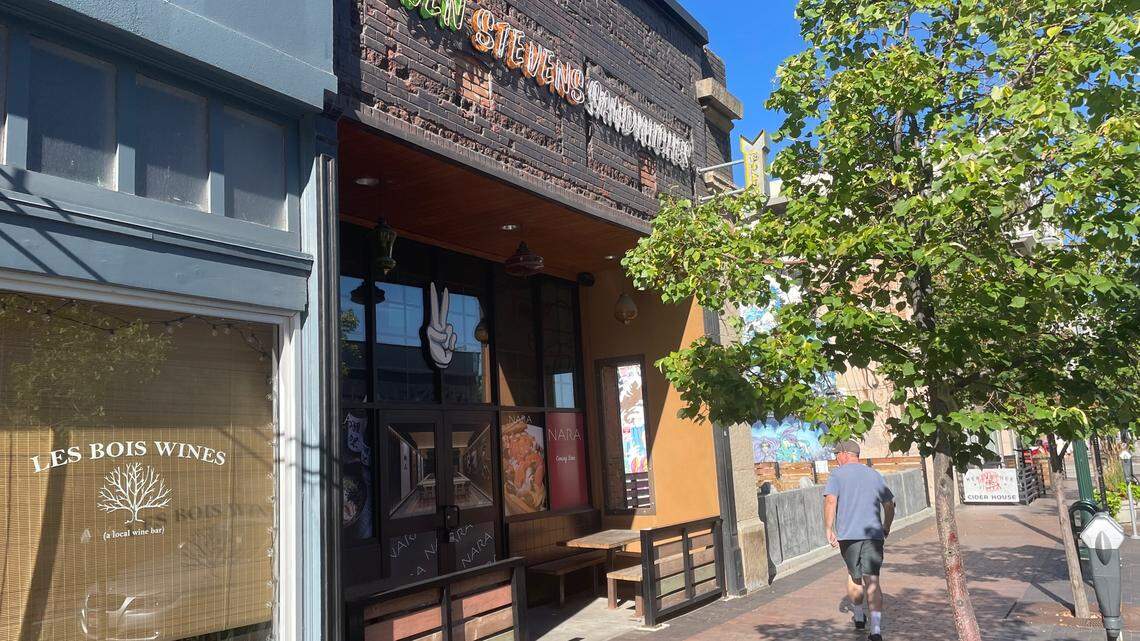 A man walks past the former Even Stevens sandwich shop in Boise, which now advertises Nara Ramen in the windows.