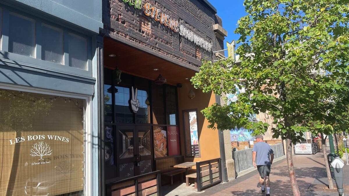 A man walks past the former Even Stevens sandwich shop in Boise, which now advertises Nara Ramen in the windows.