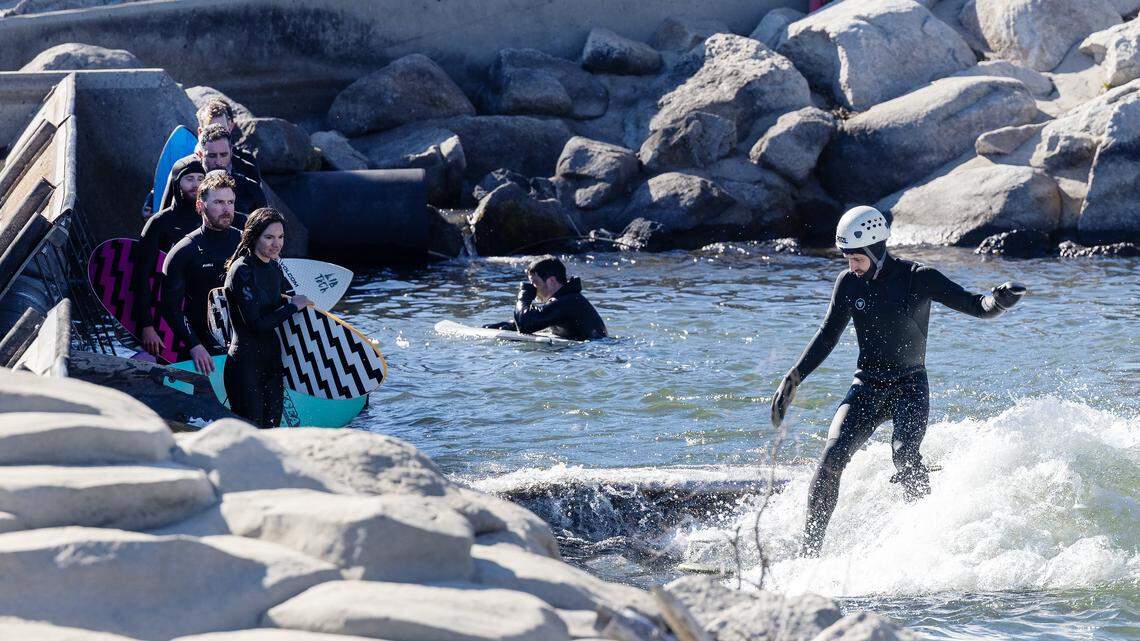Surfers wear wetsuits in the cold water of the Boise River at Boise Whitewater Park, Wednesday, March 18, 2026.