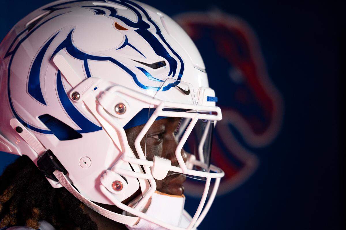 Boise State running back Ashton Jeanty models the Broncos’ white helmet with metalic blue Bronco outline.